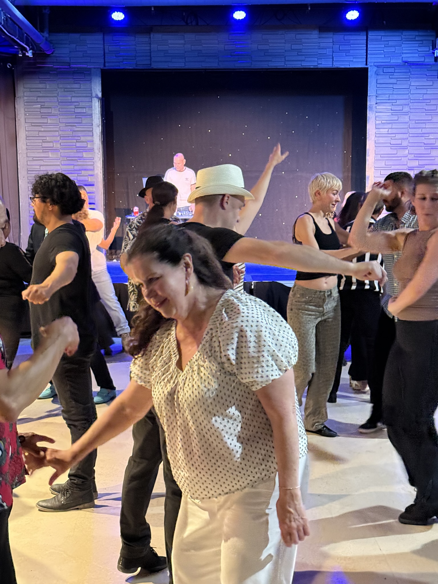 Dancers practicing Salsa under blue lights